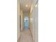 Clean hallway featuring neutral carpet, white walls, and multiple closet doors at 15164 Sunny Day Dr, Bradenton, FL 34211