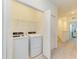 Laundry room with a modern washer and dryer and plenty of storage at 15164 Sunny Day Dr, Bradenton, FL 34211