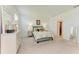 Bright and airy main bedroom featuring soft carpet, neutral walls, and patterned bedding at 15164 Sunny Day Dr, Bradenton, FL 34211