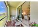 Relaxing screened patio with comfortable seating, plants, and lake views at 15164 Sunny Day Dr, Bradenton, FL 34211