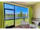 Enclosed patio with a view of the lake and surrounding neighborhood at 15164 Sunny Day Dr, Bradenton, FL 34211