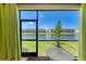 Enclosed patio with a view of the lake and surrounding neighborhood at 15164 Sunny Day Dr, Bradenton, FL 34211