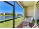 Enclosed patio with comfortable seating and a view of the lake and green space at 15164 Sunny Day Dr, Bradenton, FL 34211