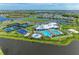Aerial view of the community's clubhouse, pools, water park, tennis courts, and green spaces at 15225 Lyla Ter, Bradenton, FL 34211