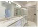 Bathroom featuring double sinks with granite counters and a glass enclosed shower at 15225 Lyla Ter, Bradenton, FL 34211