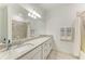 Bright bathroom with granite counters and large mirror above double sinks at 15225 Lyla Ter, Bradenton, FL 34211