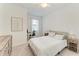 Bright bedroom with neutral carpet and paint, and a window overlooking the neighborhood at 15225 Lyla Ter, Bradenton, FL 34211