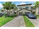 Well-maintained townhome exterior with paver driveway, landscaping, and two-car garage at 15225 Lyla Ter, Bradenton, FL 34211