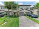 Attractive townhome exterior with a paver driveway, lush landscaping, and a two-car garage at 15225 Lyla Ter, Bradenton, FL 34211