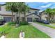 Attractive townhome exterior with a paver driveway, lush landscaping, and a two-car garage at 15225 Lyla Ter, Bradenton, FL 34211