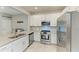 Bright kitchen features granite counters, stainless appliances, white cabinets, and tile backsplash for a modern style at 15225 Lyla Ter, Bradenton, FL 34211