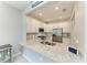 Bright kitchen features granite counters, stainless appliances, white cabinets, and tile backsplash for a modern style at 15225 Lyla Ter, Bradenton, FL 34211