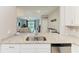 Kitchen view overlooking the living room, showcasing granite countertops, stainless appliances and open floor plan at 15225 Lyla Ter, Bradenton, FL 34211