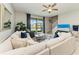 Bright living room featuring a large sectional sofa, view of the pond, and a staircase leading to the second floor at 15225 Lyla Ter, Bradenton, FL 34211