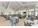 Beautiful restaurant area showcasing high ceilings, ample seating, and a well-stocked bar for residents at 15225 Lyla Ter, Bradenton, FL 34211