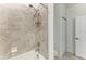 Bathroom featuring tile shower with tub, and a tile surround at 15225 Lyla Ter, Bradenton, FL 34211