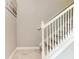 Carpeted staircase with white railings and a decorative 'Life is Good' beach theme sign at 15225 Lyla Ter, Bradenton, FL 34211