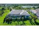 Aerial view of a home with pool, screened in lanai and lush lawn at 15315 Anchorage Pl, Lakewood Ranch, FL 34202
