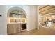 A bar area with wine cooler and sink, next to the living and kitchen area at 15315 Anchorage Pl, Lakewood Ranch, FL 34202