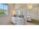 Bright powder room with a marble countertop, black hardware, and large mirror, perfect for guests at 15315 Anchorage Pl, Lakewood Ranch, FL 34202