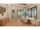 An elegant dining room features modern light fixture and access to the outdoor pool area at 15315 Anchorage Pl, Lakewood Ranch, FL 34202