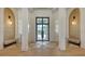 Elegant home foyer with a grand front door, high ceilings, and stylish architectural details at 15315 Anchorage Pl, Lakewood Ranch, FL 34202