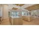 Open-concept gourmet kitchen boasting double islands with stone countertops, light wood cabinets, and modern lighting at 15315 Anchorage Pl, Lakewood Ranch, FL 34202