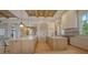 Bright kitchen featuring double islands with marble countertops, light wood cabinets, and modern appliances at 15315 Anchorage Pl, Lakewood Ranch, FL 34202