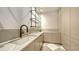 Laundry room featuring marble countertops, modern fixtures, light cabinets, and patterned floors at 15315 Anchorage Pl, Lakewood Ranch, FL 34202