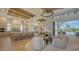 Open-concept design featuring multiple chairs, view of kitchen and dining areas, and access to the outdoor pool at 15315 Anchorage Pl, Lakewood Ranch, FL 34202