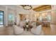 Bright living area with multiple chairs surrounding a coffee table with views into the open-concept kitchen at 15315 Anchorage Pl, Lakewood Ranch, FL 34202