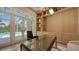 A home office features built-in shelving and french doors lead to the pool at 15315 Anchorage Pl, Lakewood Ranch, FL 34202