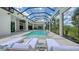 Luxury pool area with lounge chairs and a clear glass enclosure at 15315 Anchorage Pl, Lakewood Ranch, FL 34202