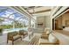 Spacious screened lanai with a large pool, and an open living area with comfortable seating at 15315 Anchorage Pl, Lakewood Ranch, FL 34202