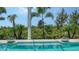 A refreshing backyard swimming pool is enhanced by a backdrop of lush tropical landscaping at 15315 Anchorage Pl, Lakewood Ranch, FL 34202