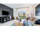 Stylish living room with modern decor, a comfortable sofa, neutral tones, and a view to the outdoors at 16538 San Nicola Pl, Bradenton, FL 34211