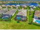 A scenic view of landscaped backyards, screened-in pools, and tile roofs in this luxurious community at 17110 Verona Pl, Bradenton, FL 34202