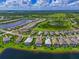 An aerial view shows a neighborhood with many houses, some with private pools and lakes surrounding at 17110 Verona Pl, Bradenton, FL 34202