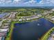 An aerial view shows many houses in a community with several lakes and lush green space at 17110 Verona Pl, Bradenton, FL 34202