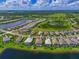 Aerial view of a home in a well-planned community with lakes, green spaces, and neatly arranged homes at 17110 Verona Pl, Bradenton, FL 34202