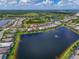 An aerial view shows the real estate property and surrounding community amenities, including lake at 17110 Verona Pl, Bradenton, FL 34202