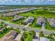 An aerial view of beautiful homes in a quiet neighborhood with lush landscaping and community lakes in the background at 17110 Verona Pl, Bradenton, FL 34202