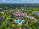 Stunning aerial view of community clubhouse with pools, tennis courts, and manicured landscaping at 17110 Verona Pl, Bradenton, FL 34202