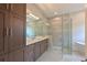 A luxurious bathroom with a glass shower, vanity with lots of storage, and a freestanding tub at 17110 Verona Pl, Bradenton, FL 34202