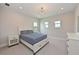 Serene bedroom featuring a chandelier, bedside tables, and natural light from two windows at 17110 Verona Pl, Bradenton, FL 34202