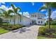 Beautiful two-story home with a paver driveway, lush landscaping, and a three-car garage at 17110 Verona Pl, Bradenton, FL 34202