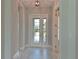 Bright foyer featuring a tile floor and glass front doors leading to a landscaped view at 17110 Verona Pl, Bradenton, FL 34202