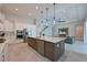 Open concept kitchen featuring an island, stainless steel appliances, and views of the living room at 17110 Verona Pl, Bradenton, FL 34202