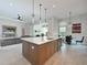 Modern kitchen with an island, stainless steel appliances, tile floors, and an adjacent seating area at 17110 Verona Pl, Bradenton, FL 34202