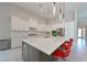 Spacious open concept kitchen with an island, stainless steel appliances, and red bar stool seating at 17110 Verona Pl, Bradenton, FL 34202